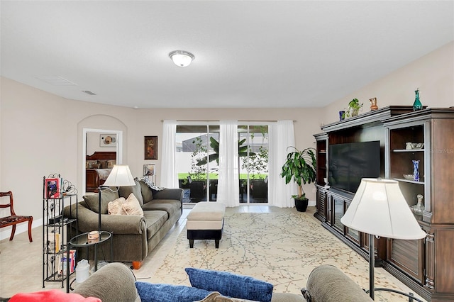 living room featuring baseboards and visible vents