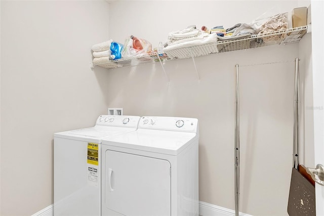 clothes washing area featuring laundry area and washer and clothes dryer