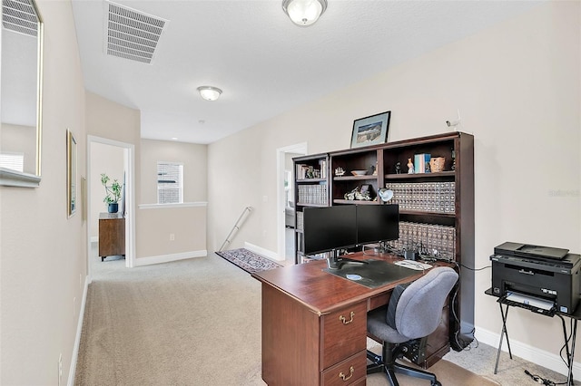 carpeted home office featuring baseboards and visible vents