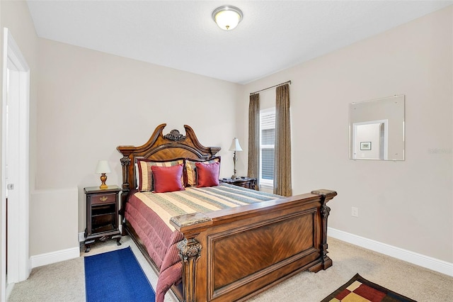 bedroom with light carpet and baseboards