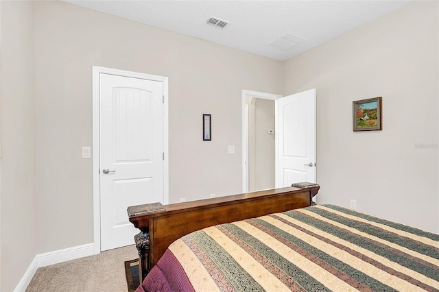 carpeted bedroom with visible vents and baseboards