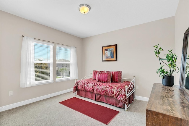 bedroom with baseboards and light carpet