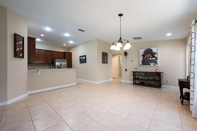 11908 Fiore Dr Unit 1, Orlando, FL 32827 - unfurnished living room with a chandelier, recessed lighting, light tile patterned flooring, and baseboards