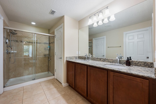 11908 Fiore Dr Unit 1, Orlando, FL 32827 - full bathroom featuring a stall shower, tile patterned floors, double vanity, a textured ceiling, and recessed lighting