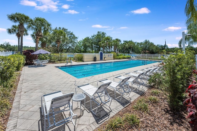 11908 Fiore Dr Unit 1, Orlando, FL 32827 - community pool with fence and a patio area