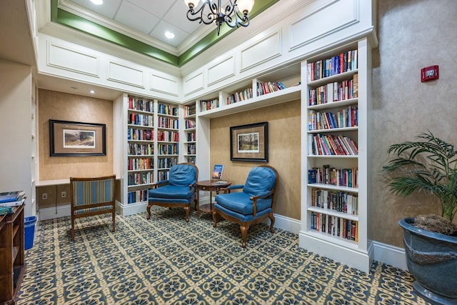 11908 Fiore Dr Unit 1, Orlando, FL 32827 - living area featuring wall of books, a chandelier, built in features, baseboards, and crown molding