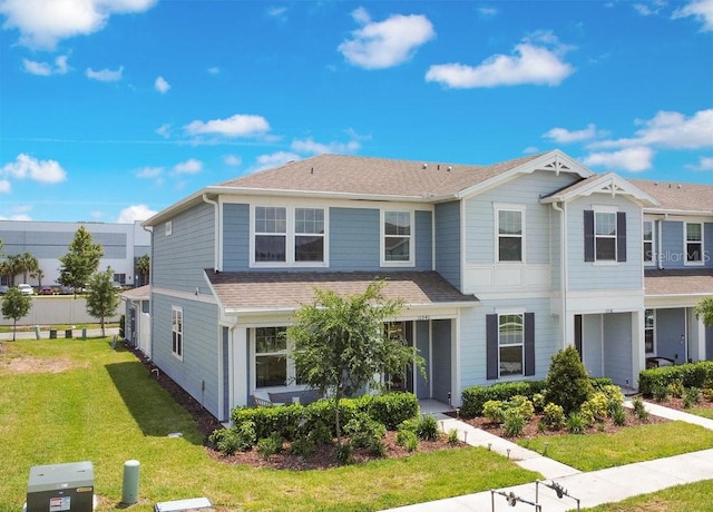 10940 Leafshore Loop, Orlando, FL 32829 - view of front of home featuring a shingled roof and a front lawn
