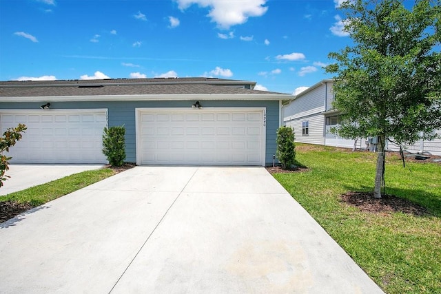 10940 Leafshore Loop, Orlando, FL 32829 - view of front facade with a front lawn, concrete driveway, and a garage