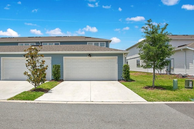 10940 Leafshore Loop, Orlando, FL 32829 - townhome / multi-family property with a front yard and driveway