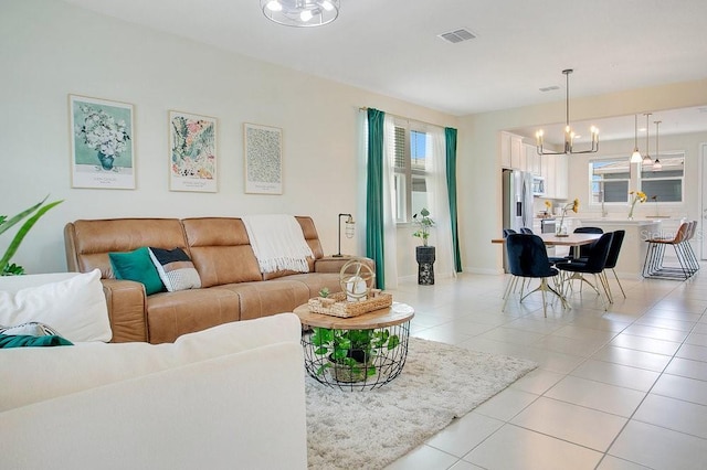 10940 Leafshore Loop, Orlando, FL 32829 - living room featuring a chandelier, light tile patterned floors, and baseboards