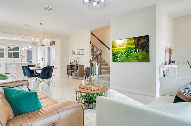 10940 Leafshore Loop, Orlando, FL 32829 - living room with light tile patterned floors, a chandelier, stairway, and baseboards