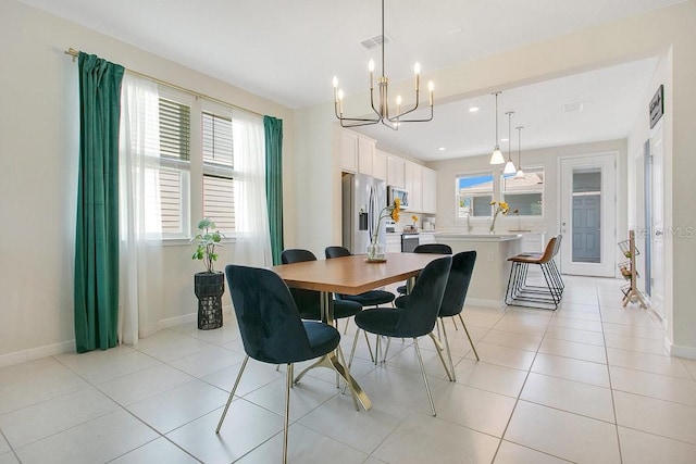 10940 Leafshore Loop, Orlando, FL 32829 - dining area featuring a chandelier, baseboards, light tile patterned floors, and recessed lighting