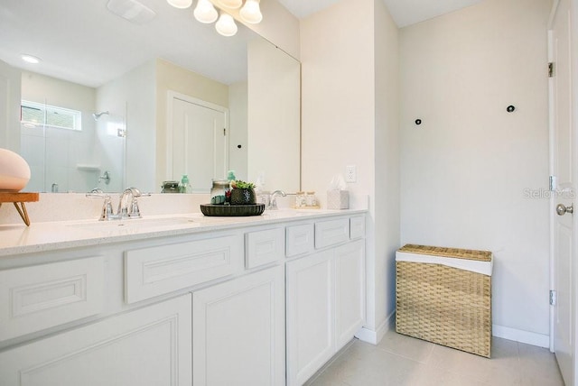 10940 Leafshore Loop, Orlando, FL 32829 - full bathroom with a walk in shower, baseboards, tile patterned floors, and double vanity