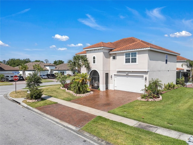 mediterranean / spanish-style home with a tiled roof, stucco siding, a garage, decorative driveway, and a front yard