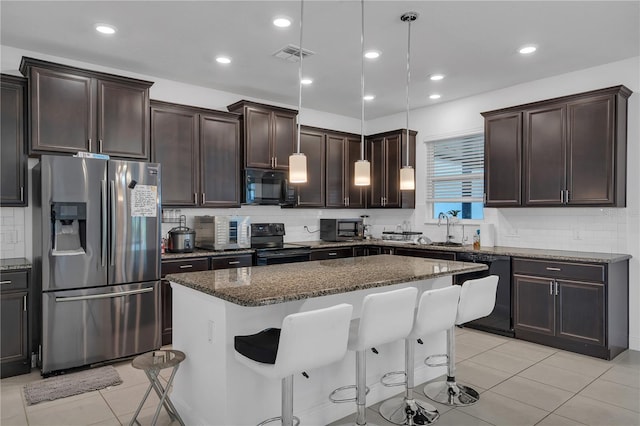 kitchen featuring black appliances, backsplash, a breakfast bar area, light tile patterned flooring, and recessed lighting