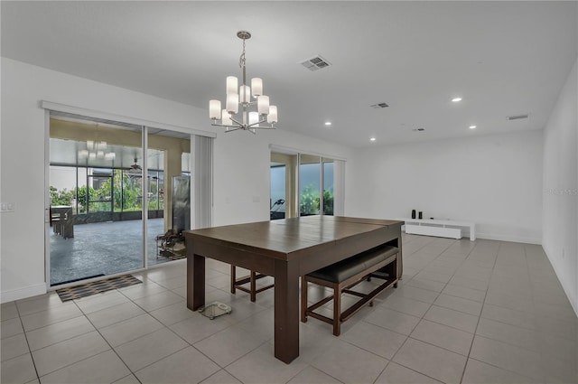 dining space featuring a chandelier, plenty of natural light, light tile patterned floors, baseboards, and recessed lighting