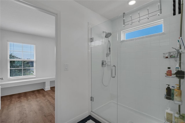 full bathroom featuring a shower stall, wood finished floors, baseboards, and recessed lighting