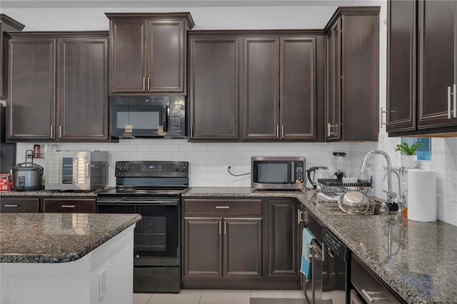 kitchen with black appliances, dark stone counters, backsplash, and dark brown cabinets