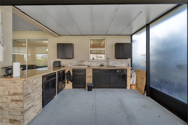 kitchen featuring light countertops, a sink, and light carpet