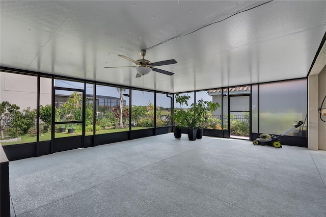 unfurnished sunroom with ceiling fan