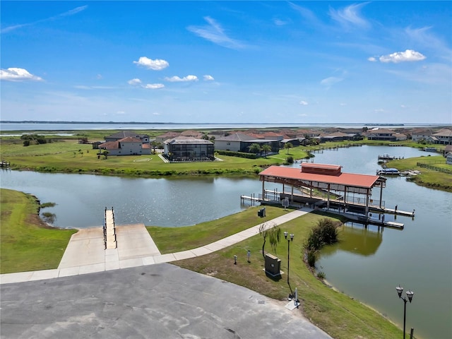 dock area featuring boat lift and a water view