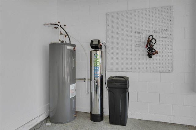 detailed view of electric water heater, concrete block wall, and speckled floor