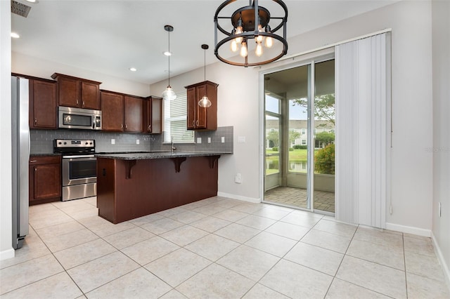 kitchen featuring stainless steel appliances, decorative backsplash, a peninsula, light tile patterned flooring, and recessed lighting