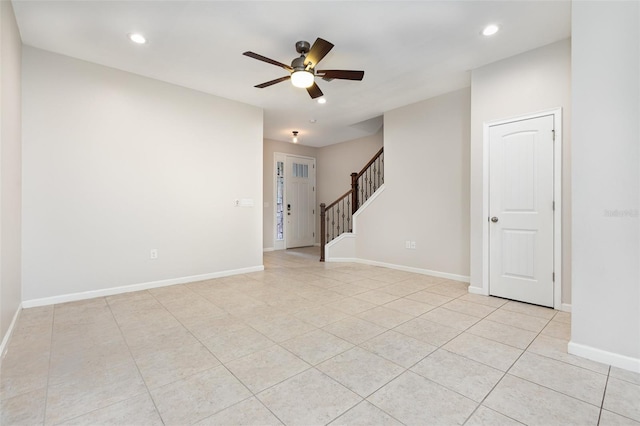 empty room featuring stairs, ceiling fan, recessed lighting, light tile patterned floors, and baseboards