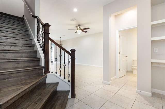 staircase with ceiling fan, tile patterned floors, baseboards, and recessed lighting