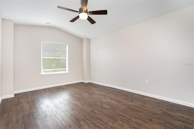 spare room with lofted ceiling, a ceiling fan, dark wood-style floors, and baseboards