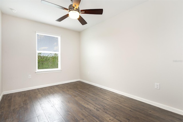 unfurnished room with baseboards, dark wood-type flooring, a ceiling fan, and a smoke detector