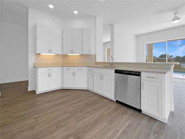 5154 51st Ln W, Bradenton, FL 34210 - kitchen with light countertops, a sink, light wood-type flooring, white cabinetry, and dishwasher