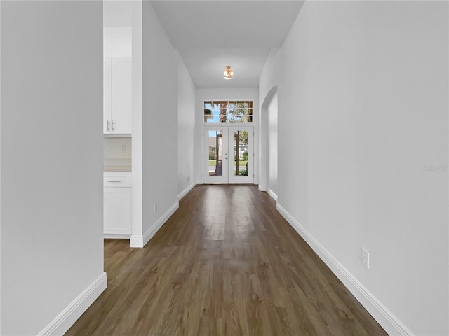 5154 51st Ln W, Bradenton, FL 34210 - hallway featuring wood finished floors, french doors, baseboards, and arched walkways
