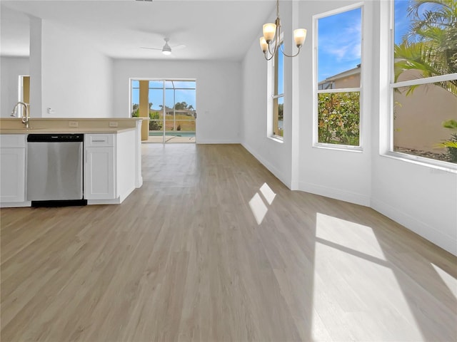 5154 51st Ln W, Bradenton, FL 34210 - kitchen featuring dishwasher, white cabinetry, open floor plan, light countertops, and baseboards