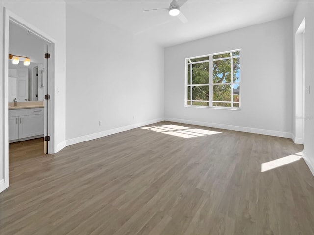5154 51st Ln W, Bradenton, FL 34210 - unfurnished bedroom with ensuite bathroom, wood finished floors, baseboards, and a sink