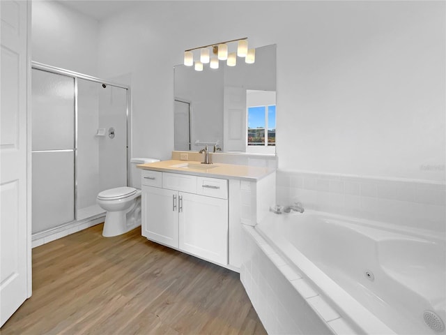5154 51st Ln W, Bradenton, FL 34210 - bathroom featuring toilet, wood finished floors, vanity, a stall shower, and a bath
