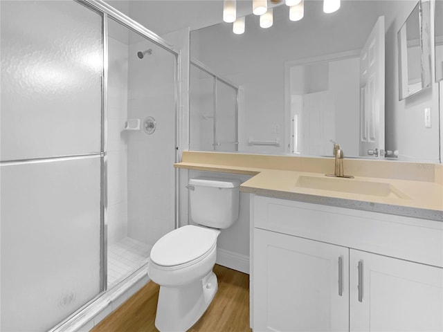 5154 51st Ln W, Bradenton, FL 34210 - bathroom featuring vanity, toilet, wood finished floors, and a shower stall