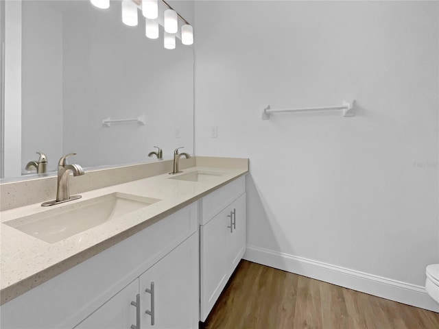 5154 51st Ln W, Bradenton, FL 34210 - full bath featuring baseboards, double vanity, a sink, and wood finished floors