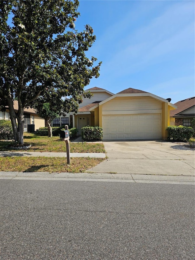 view of front of house with a garage and concrete driveway