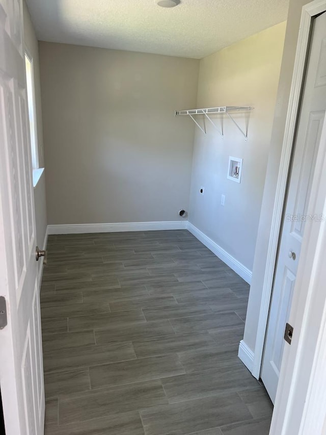 washroom with baseboards, dark wood-style flooring, hookup for a washing machine, and laundry area