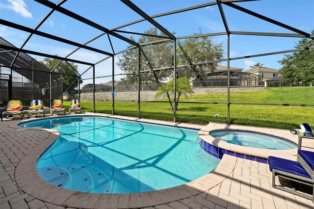 2624 Daulby St, Kissimmee, FL 34747 - view of swimming pool with a lawn, a pool with connected hot tub, a patio, and a lanai