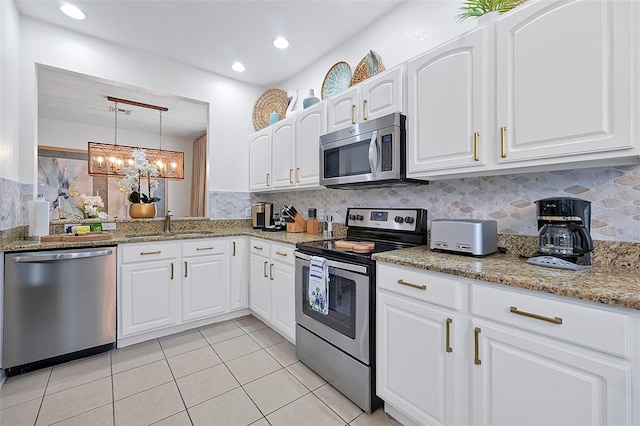 2624 Daulby St, Kissimmee, FL 34747 - kitchen with appliances with stainless steel finishes, a sink, tasteful backsplash, light tile patterned floors, and recessed lighting