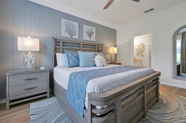 2624 Daulby St, Kissimmee, FL 34747 - bedroom featuring wood finished floors, ensuite bathroom, ceiling fan, and baseboards