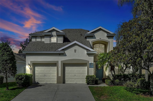 2624 Daulby St, Kissimmee, FL 34747 - view of front facade with stucco siding, concrete driveway, an attached garage, a shingled roof, and a yard