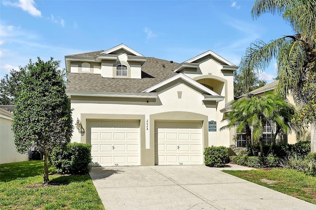 2624 Daulby St, Kissimmee, FL 34747 - view of front of house with driveway, stucco siding, and roof with shingles