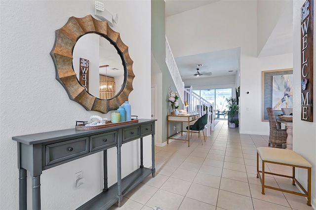 2624 Daulby St, Kissimmee, FL 34747 - hall with light tile patterned floors, a chandelier, and baseboards