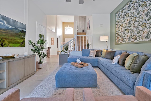 2624 Daulby St, Kissimmee, FL 34747 - living area featuring light tile patterned floors, a ceiling fan, and stairs