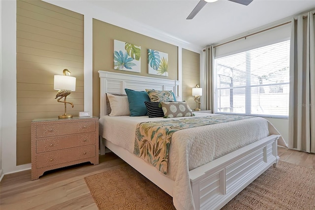 2624 Daulby St, Kissimmee, FL 34747 - bedroom featuring light wood-type flooring, ceiling fan, wooden walls, and baseboards