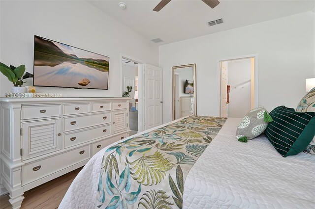 2624 Daulby St, Kissimmee, FL 34747 - bedroom with dark wood-type flooring, ceiling fan, and connected bathroom