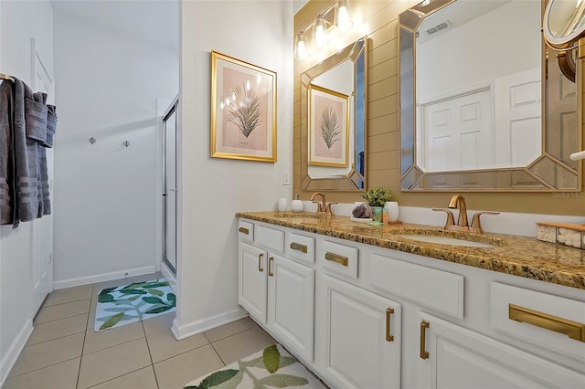 2624 Daulby St, Kissimmee, FL 34747 - bathroom featuring tile patterned flooring, a stall shower, baseboards, and double vanity